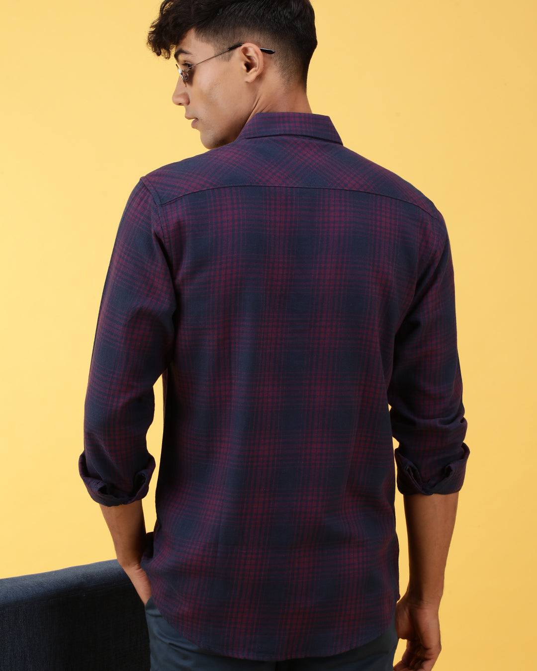 Man wearing a pink dark pink checked full sleeve 100% cotton shirt on a light gray background