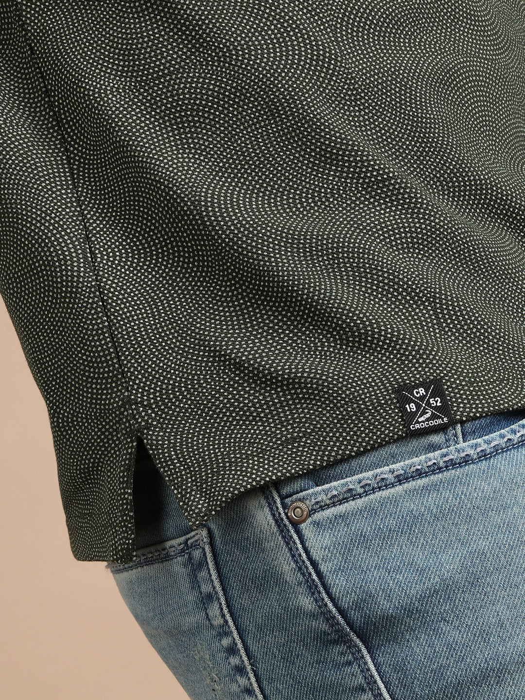 Man wearing a green printed kombu green casual polo t shirt with casual styling on a gray background