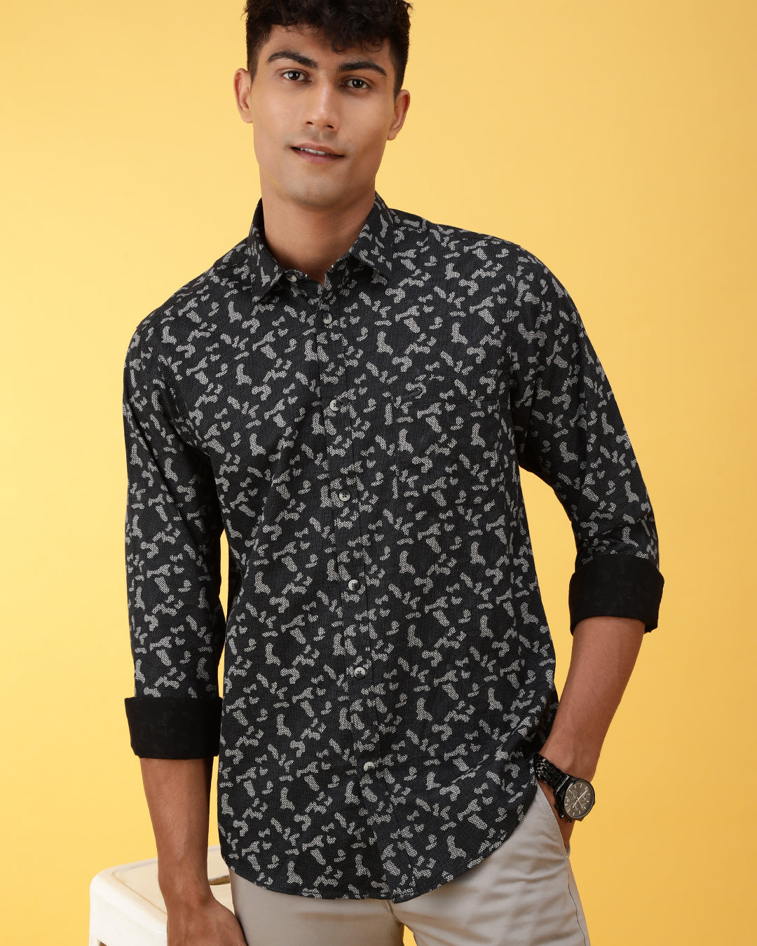 Man wearing a black printed full sleeve 100% cotton shirt black on a light gray background