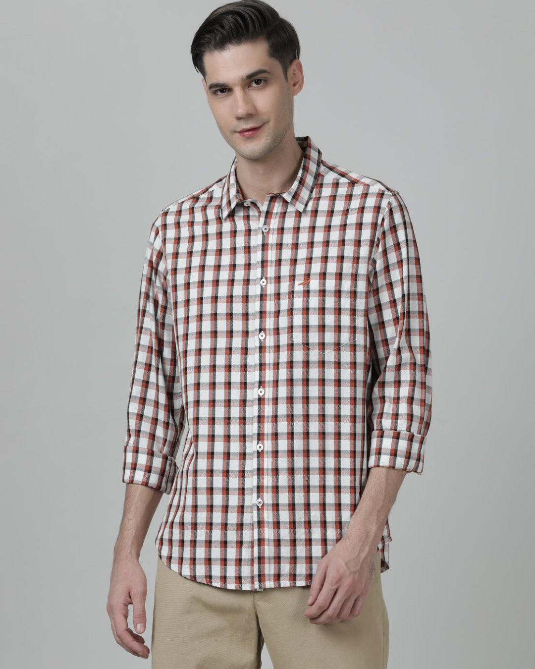 Man wearing a red brick red checked full sleeve 100% cotton shirt on a light gray background