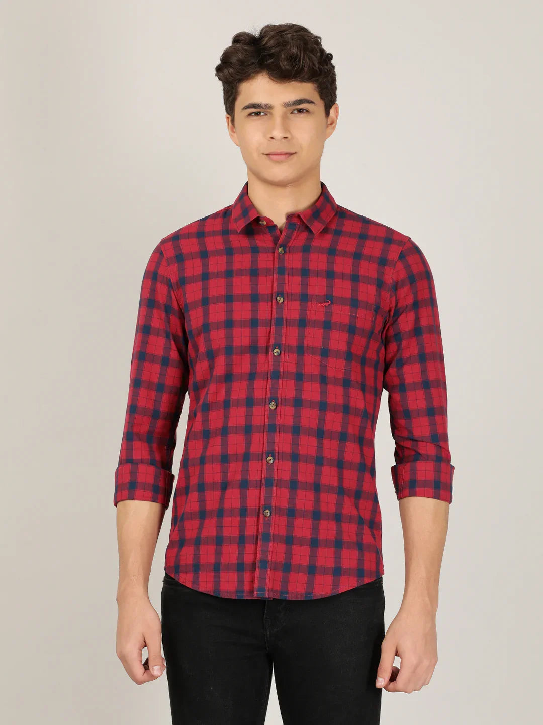 Man wearing a red red checked full sleeve 100% cotton casual shirt on a light gray background