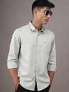 Man wearing a green pale green solid full sleeve 100% cotton shirt on a light gray background