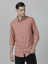 Man wearing a red light red checked full sleeve 100% cotton shirt on a light gray background