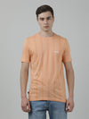 Man wearing a pink coral pink striped casual t shirt with casual styling on a gray background