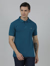 Man wearing a blue solid slim fit blue polo t shirt with pocket on a light gray background