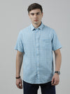 Man wearing a blue aqua blue checked half sleeve linen shirt on a light gray background