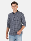 Man wearing a navy navy casual checked full sleeve shirt on a light gray background