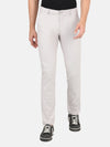 Man wearing a brown stone brown solid slim fit casual trouser with casual styling on a gray background