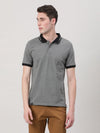 Man wearing a grey dark grey printed polo t shirt with casual styling on a gray background