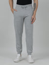 Man wearing a grey classic fit solid grey melange joggers on a light gray background