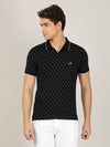 Man wearing a black printed polo t shirt black on a light gray background