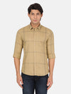 Man wearing a brown teak brown checked full sleeve shirt on a light gray background