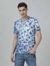 Man wearing a blue midnight blue tie and dye slim fit t shirt on a light gray background