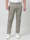 Man wearing a green light green solid slim fit casual trouser with casual styling on a gray background