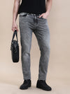 Man wearing a towel washed slim fit jeans with casual styling on a gray background