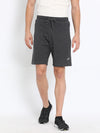 Man wearing a charcoal melange relax fit track shorts with casual styling on a gray background