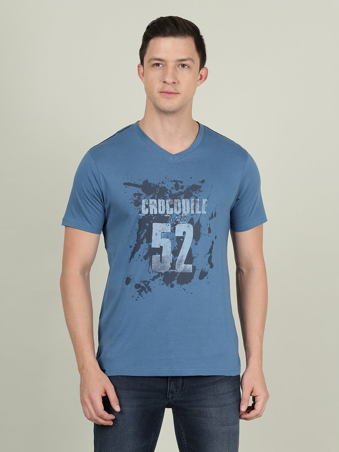 Man wearing a blue royal blue casual printed t shirt on a light gray background