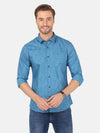 Man wearing a blue river blue printed full sleeve shirt on a light gray background