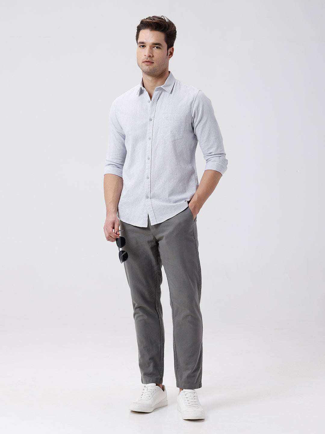 Man wearing a grey rib textured cotton shirt grey on a light gray background
