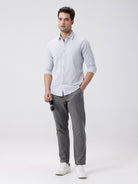 Man wearing a grey rib textured cotton shirt grey on a light gray background