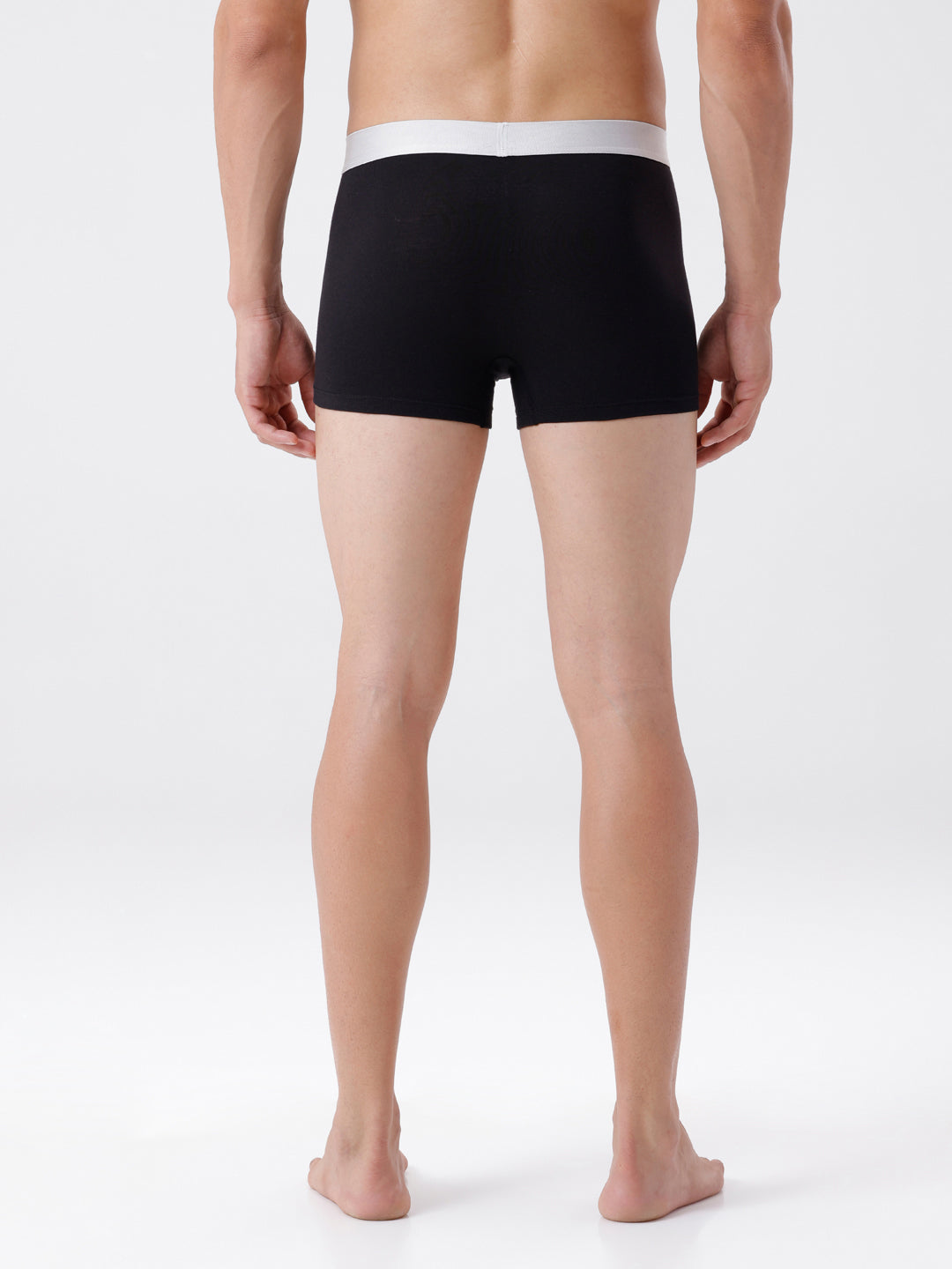 Person wearing black boxer briefs on a white background