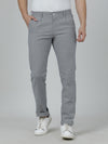 Man wearing a black solid black slim fit casual trouser on a light gray background