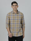 Man wearing a brown khaki brown checked full sleeve 100% cotton shirt with casual styling on a gray background