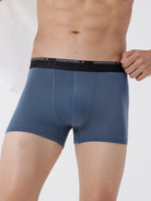 Blue boxer briefs with a black waistband on a white background