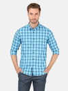 Man wearing a blue checked blue full sleeve casual shirt with casual styling on a gray background