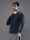Man wearing a blue denim melange casual blue solid t shirt on a light gray background