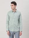 Man wearing a blue pale aqua blue solid full sleeve 100% cotton shirt with casual styling on a gray background