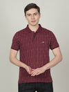 Man wearing a red wine red printed casual polo t shirt on a light gray background
