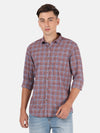 Man wearing a maroon casual checked full sleeve shirt on a light gray background