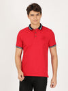 Man wearing a red solid red polo t shirt on a light gray background