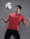 Man wearing a red casual red melange solid t shirt with casual styling on a gray background