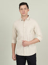 Man wearing a beige beige solid full sleeve linen casual shirt with casual styling on a gray background