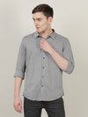 Man wearing a grey grey printed full sleeve 100% cotton casual shirt with casual styling on a gray background
