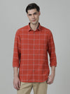Man wearing a red brick red checked full sleeve shirt with casual styling on a gray background