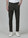 Man wearing a green olive green casual solid trouser with casual styling on a gray background