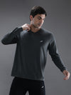Man wearing a grey charcoal melange grey solid t shirt with casual styling on a gray background