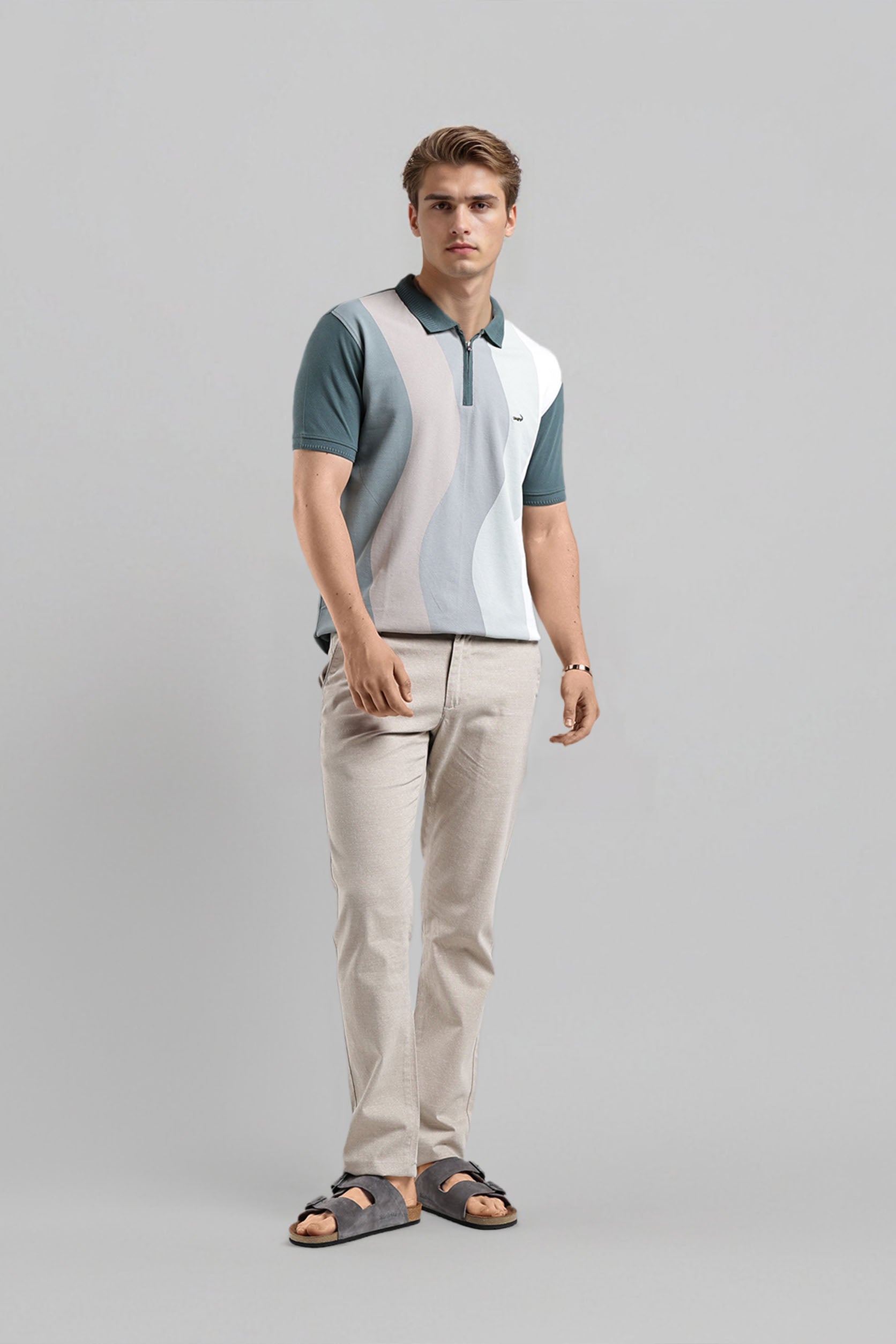 Man wearing a color-blocked polo shirt and beige pants on a gray background
