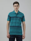 Man wearing a green casual green striped polo t shirt with casual styling on a gray background