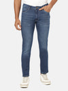 Man wearing a blue light blue solid mid rise slim tapered casual jean on a light gray background