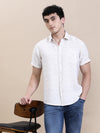 Man wearing a beige printed crinkled effect fluid half sleeve shirt beige with casual styling on a gray background
