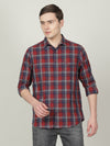 Man wearing a navy indigo navy checked full sleeve 100% cotton shirt on a light gray background