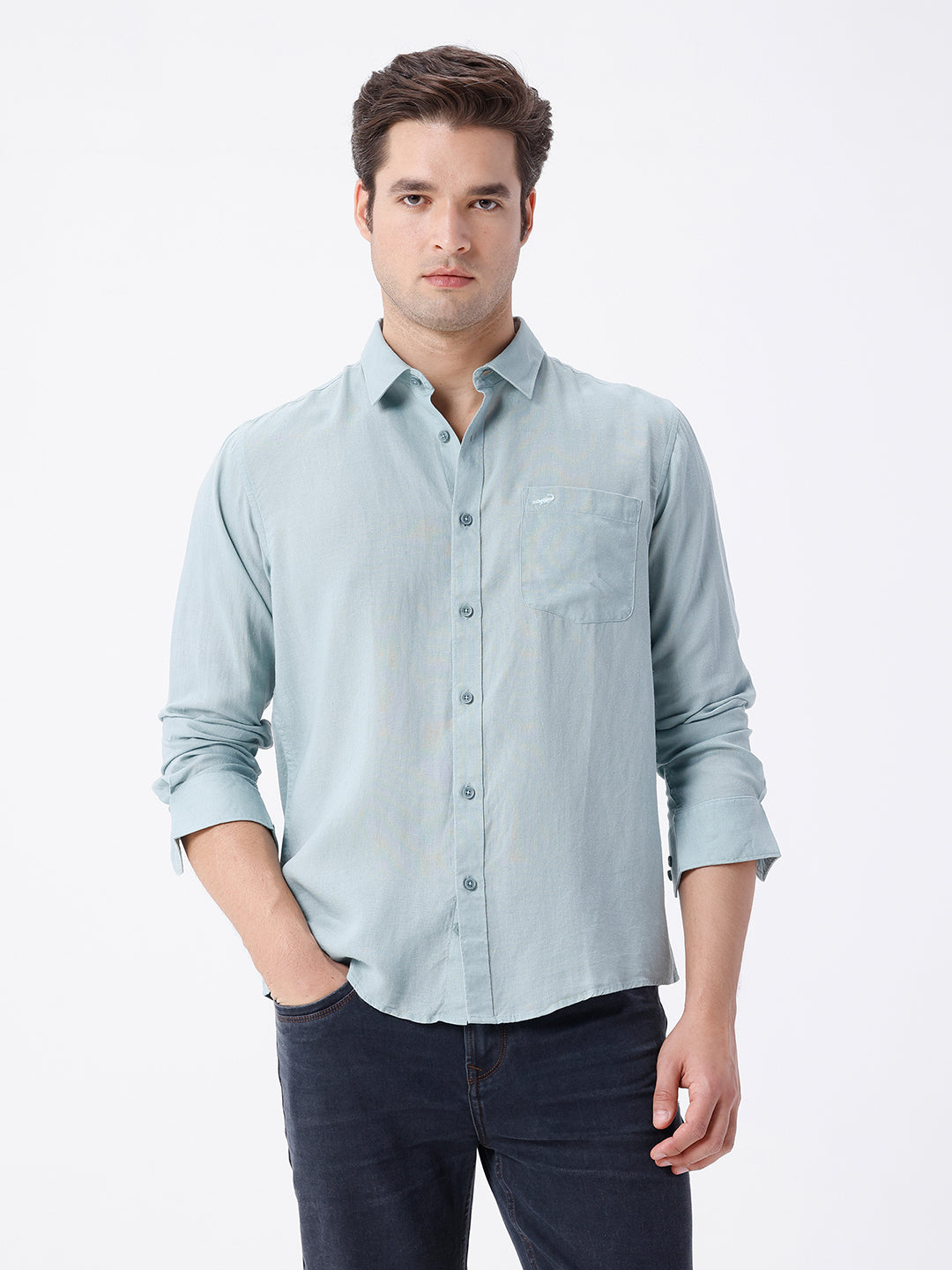 Man wearing a green linen blend shirt in green on a light gray background