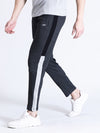 Man wearing a grey solid slim fit charcoal grey track pant on a light gray background