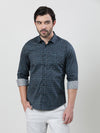 Man wearing a blue dark blue printed full sleeve 100% cotton shirt with casual styling on a gray background