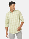 Man wearing a green casual green checked full sleeve shirt with casual styling on a gray background