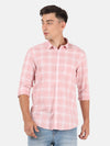Man wearing a pink pink checked casual full sleeve shirt on a light gray background